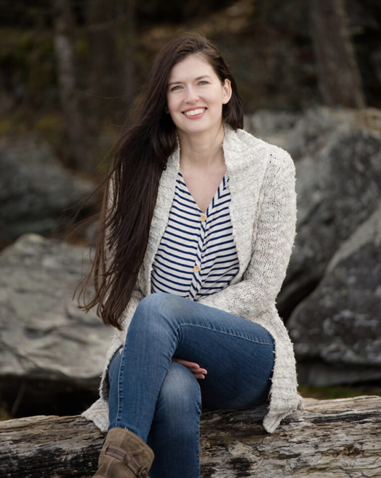 Jillian Johnsrud sitting on a log
